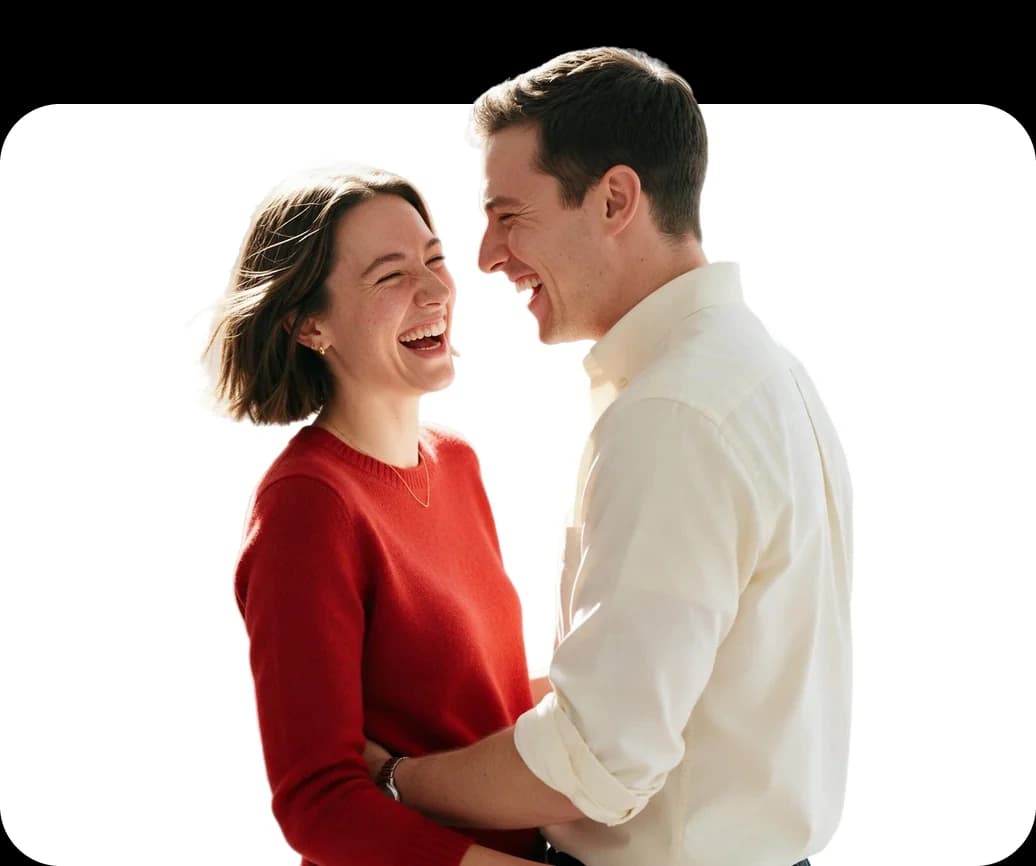 A young couple holding each other and laughing together